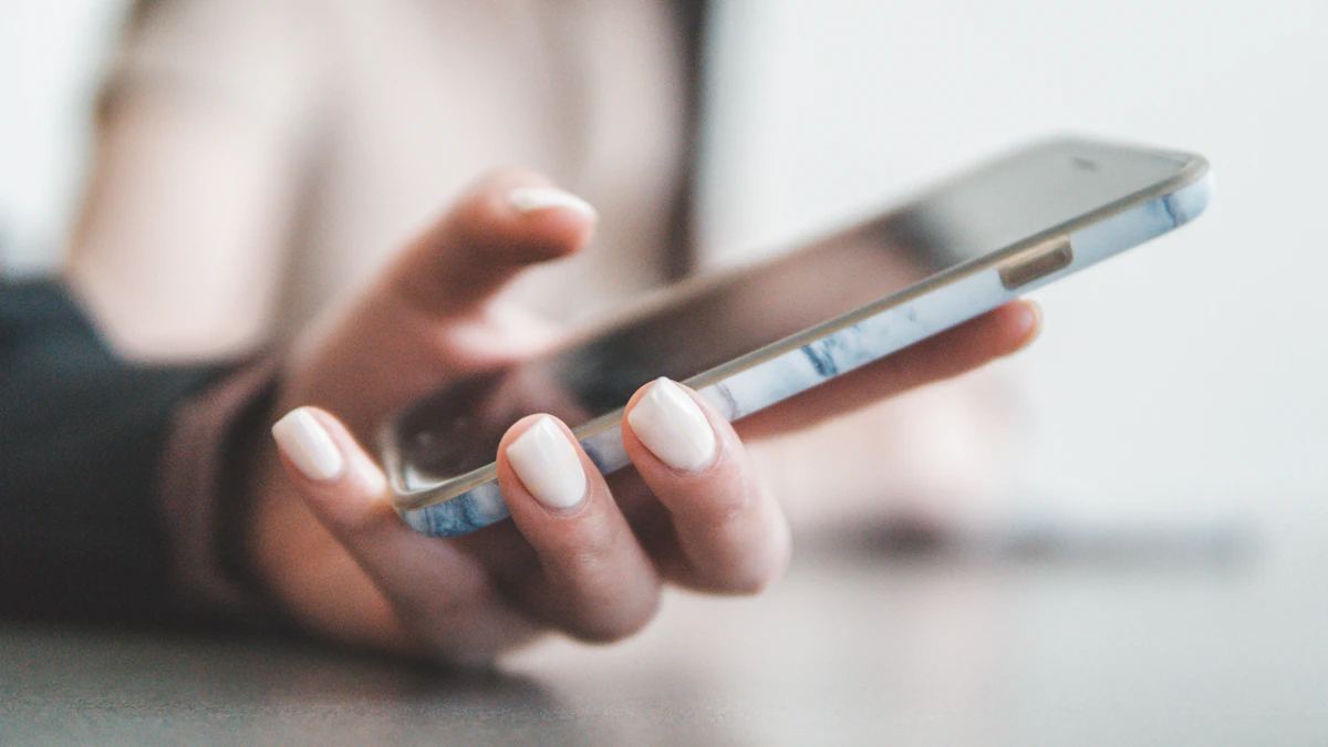A hand holding a smartphone over a table