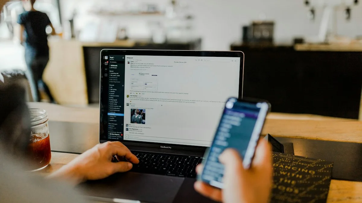 A person using a phone and a laptop at the same time