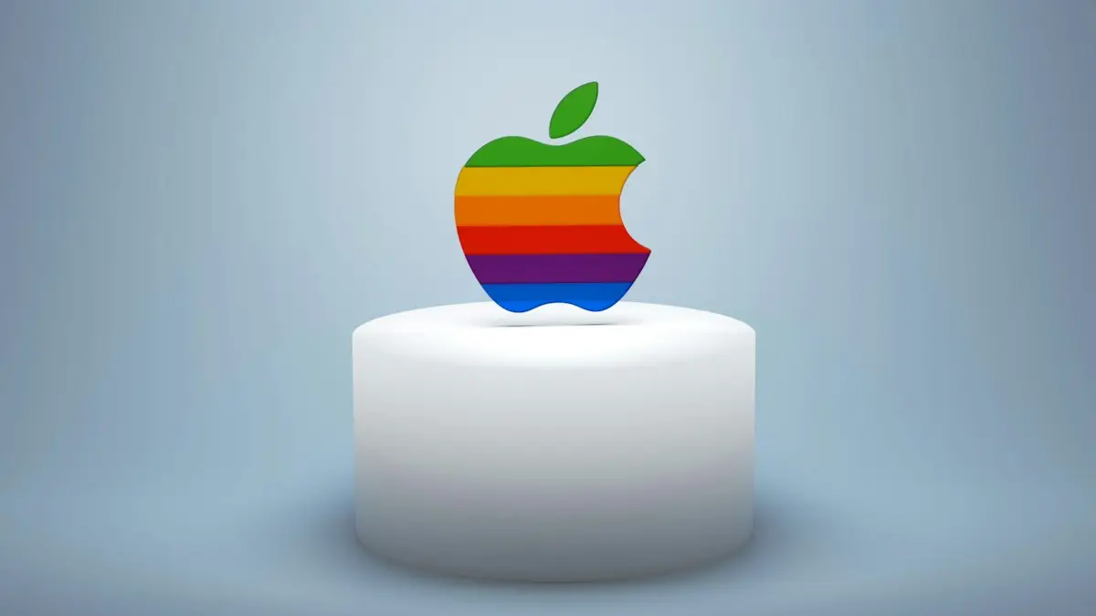 A rainbow apple sitting on top of a white cake
