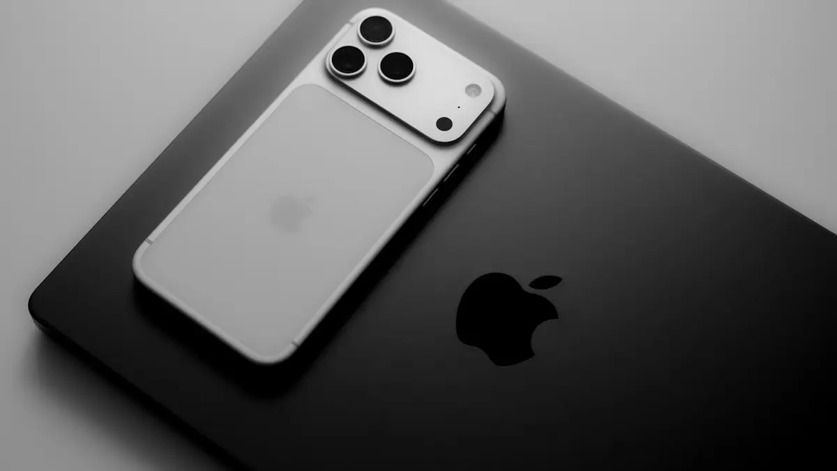 Silver smartphone resting on a black laptop