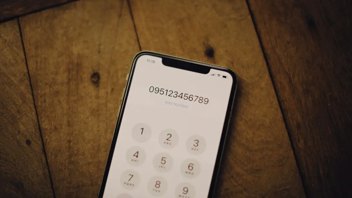 A cell phone sitting on top of a wooden table