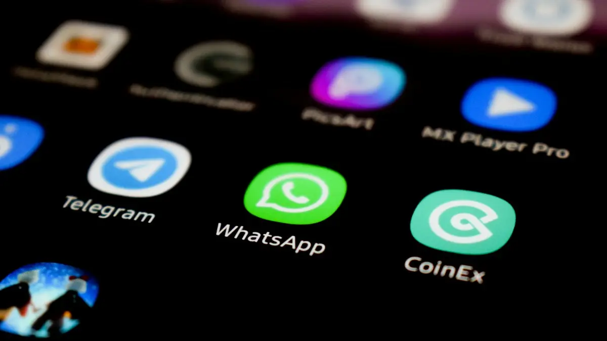 A close up of a cell phone with whatsapp on the screen
