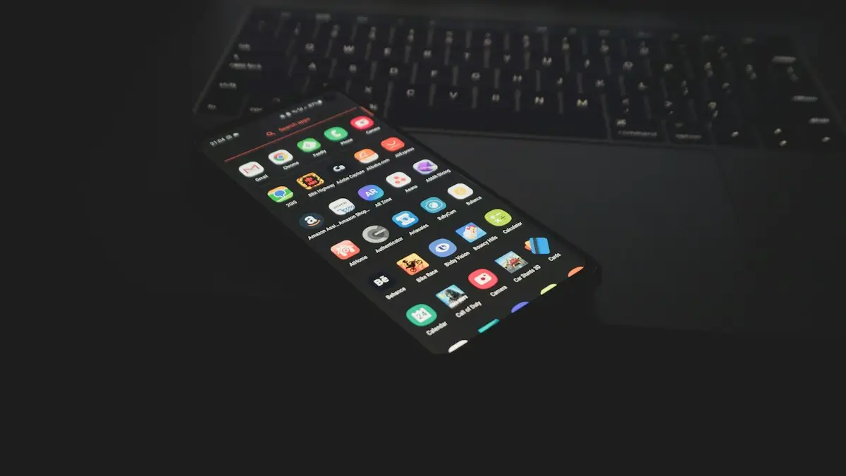 Black iphone 5 on black computer keyboard