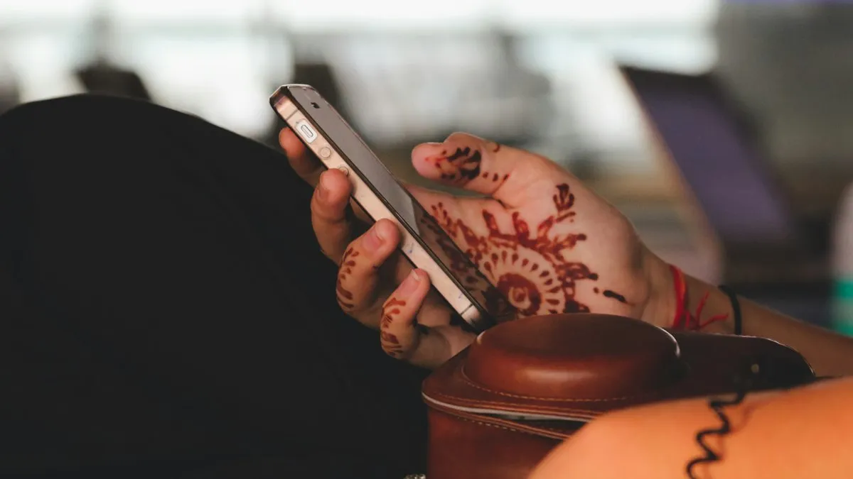 A person holding a black iPhone
