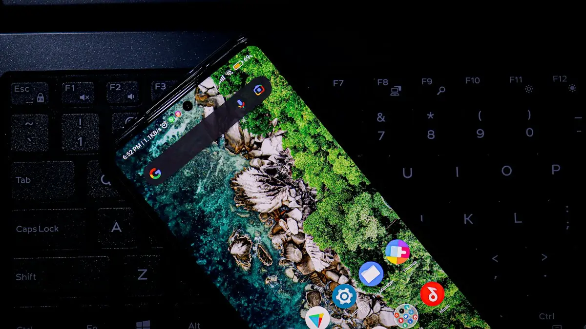 A cell phone sitting on top of a computer keyboard