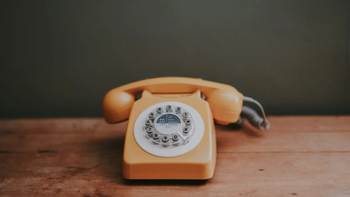 Brown rotary dial telephone in gray painted room