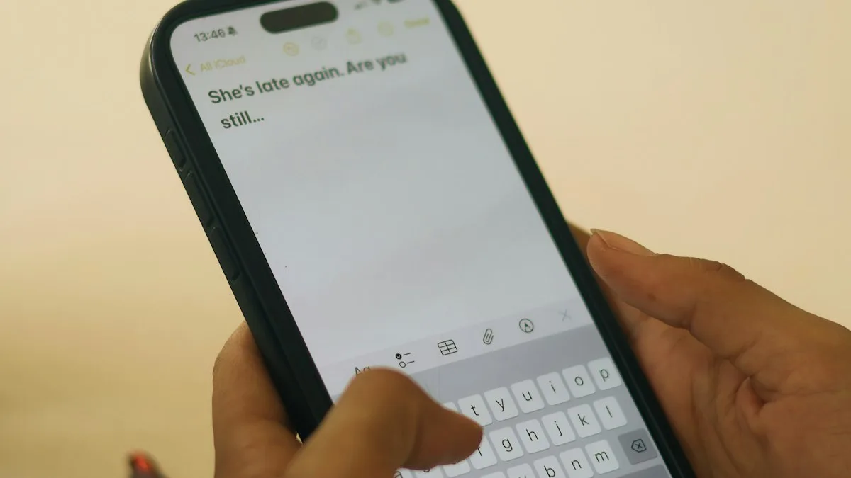 Hands typing a message on a smartphone screen