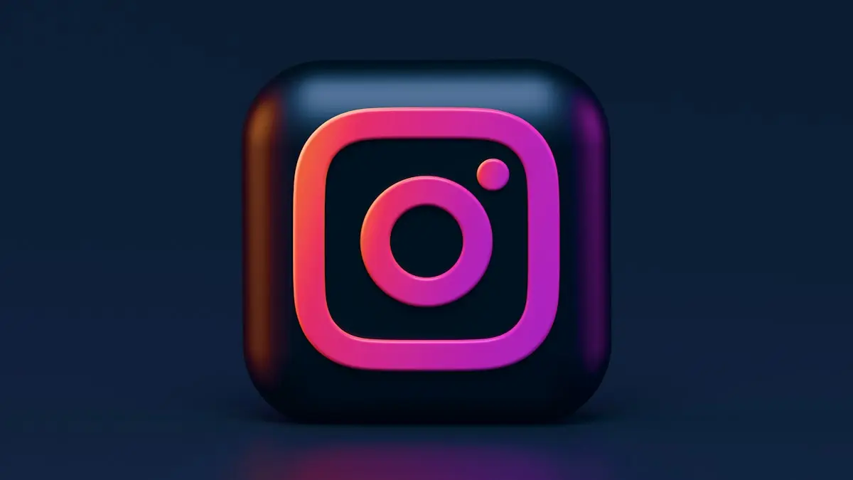 A three-dimensional Instagram logo icon with pink and orange gradient lighting
