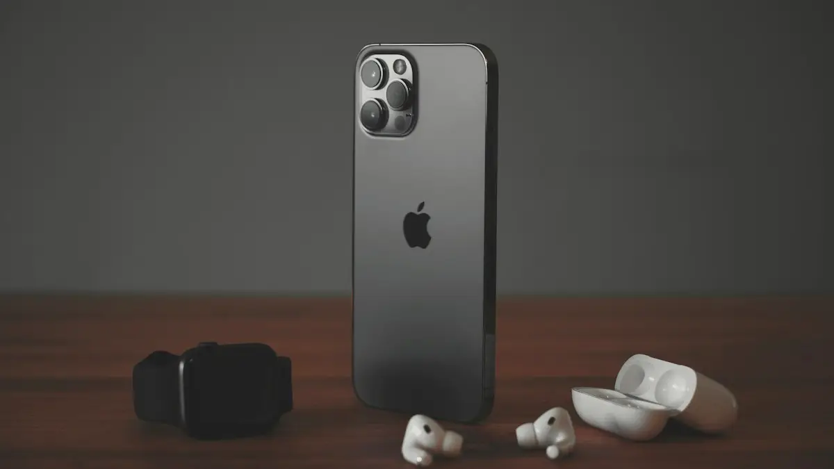 A smartphone, a smartwatch, and wireless earbuds on a wooden surface