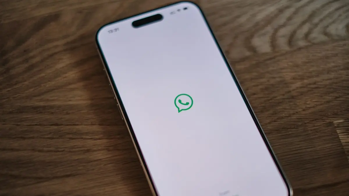 A white phone with a green message bubble on it