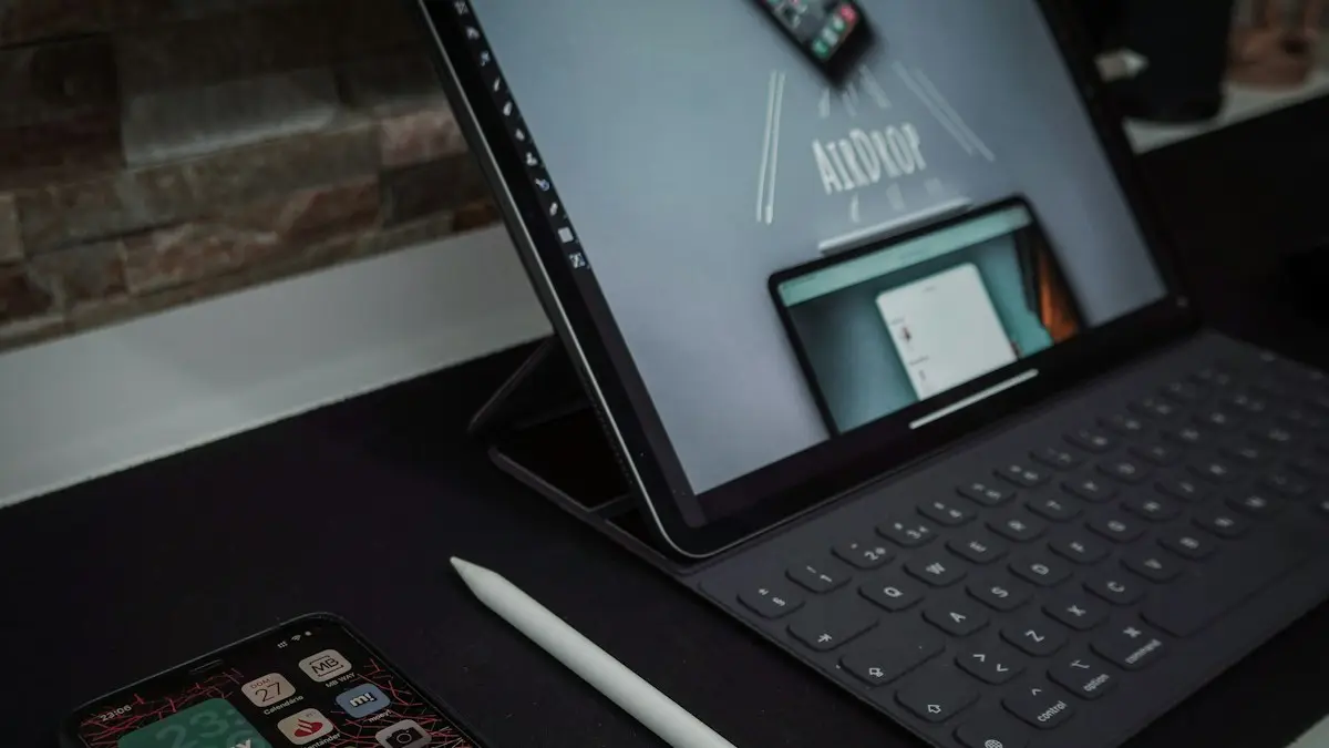 Black laptop computer turned on beside white pen