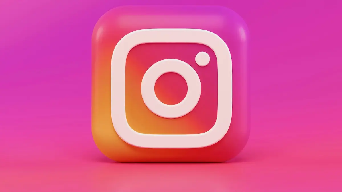A three-dimensional Instagram logo icon with a pink and orange gradient background