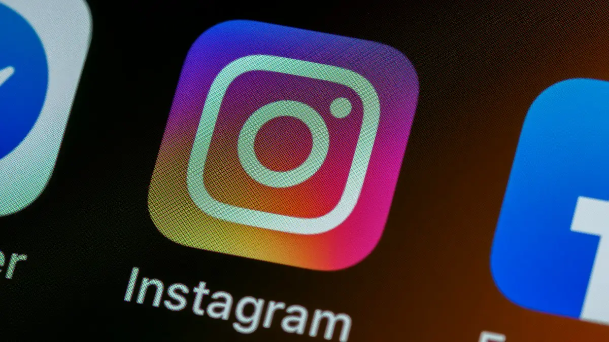 The Instagram app icon on a smartphone screen with other app icons