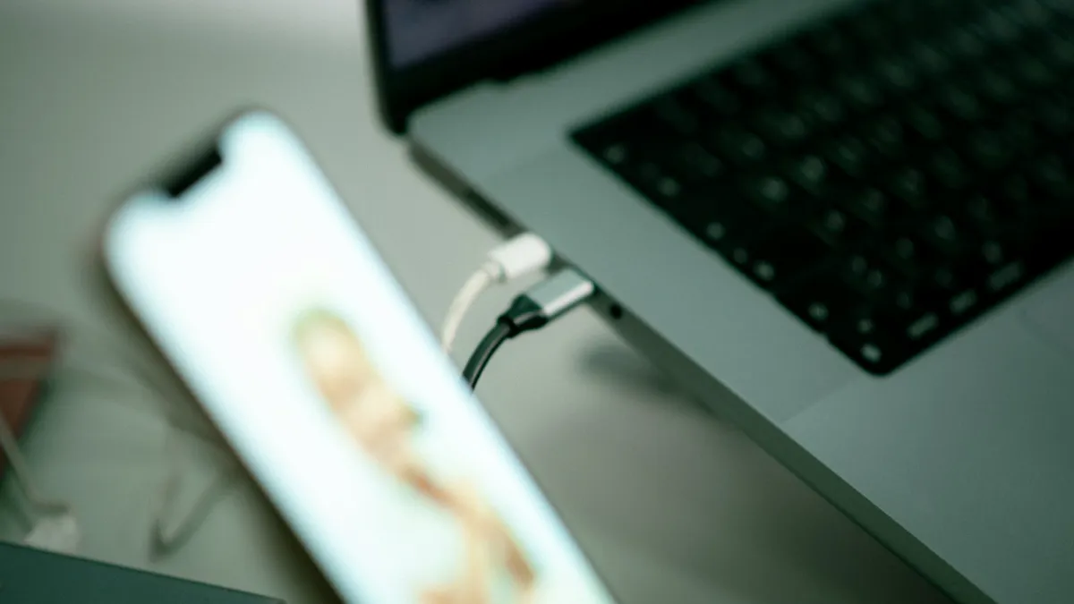 An iPhone connected to a laptop with a USB cable