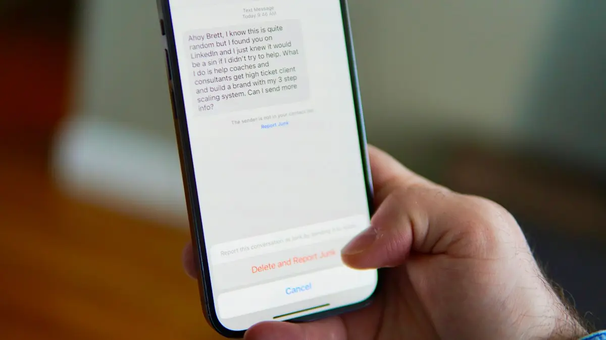 Hand holding a smartphone displaying a text message conversation