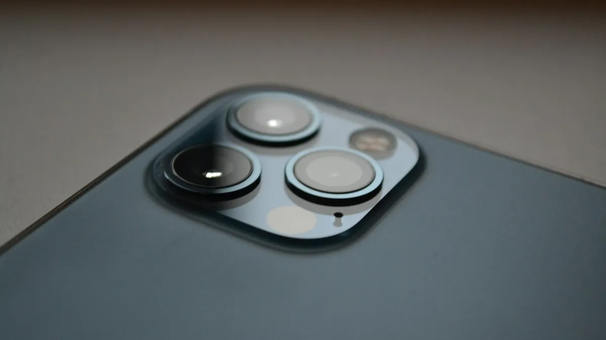 Close-up of the back corner of an iPhone with its camera lenses