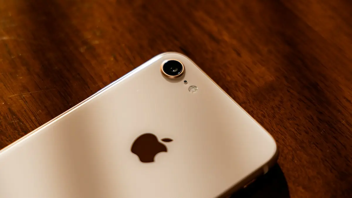 A close up of an iphone on a wooden table