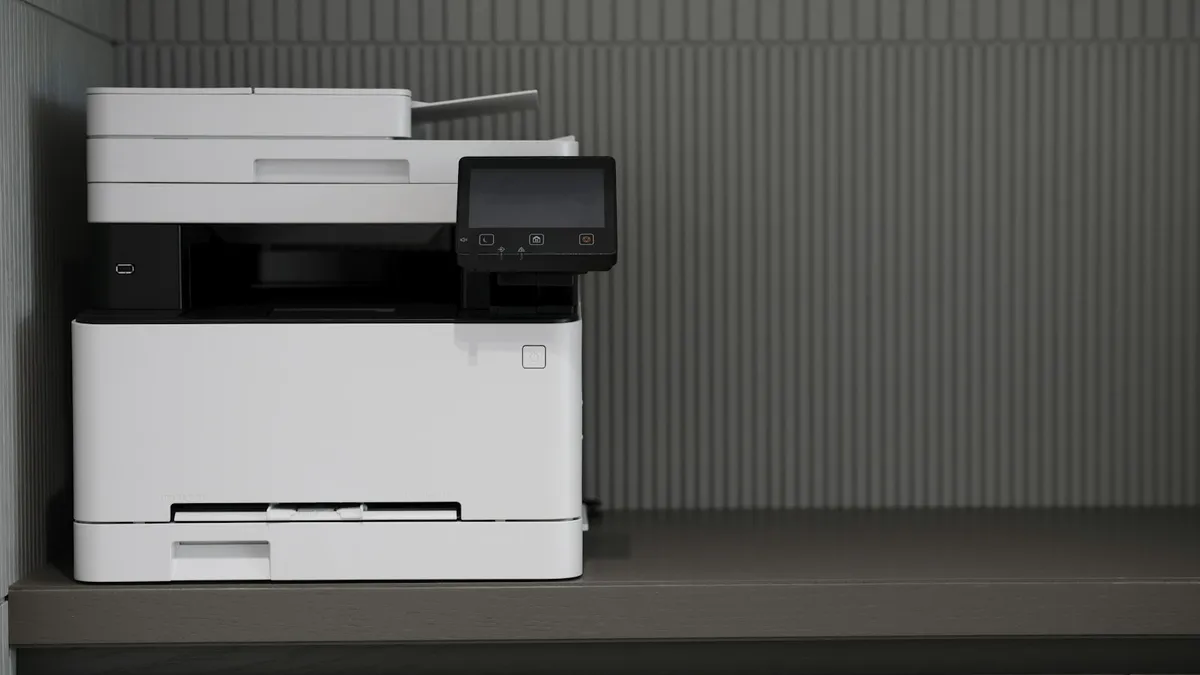 A white and black printer sitting on a counter