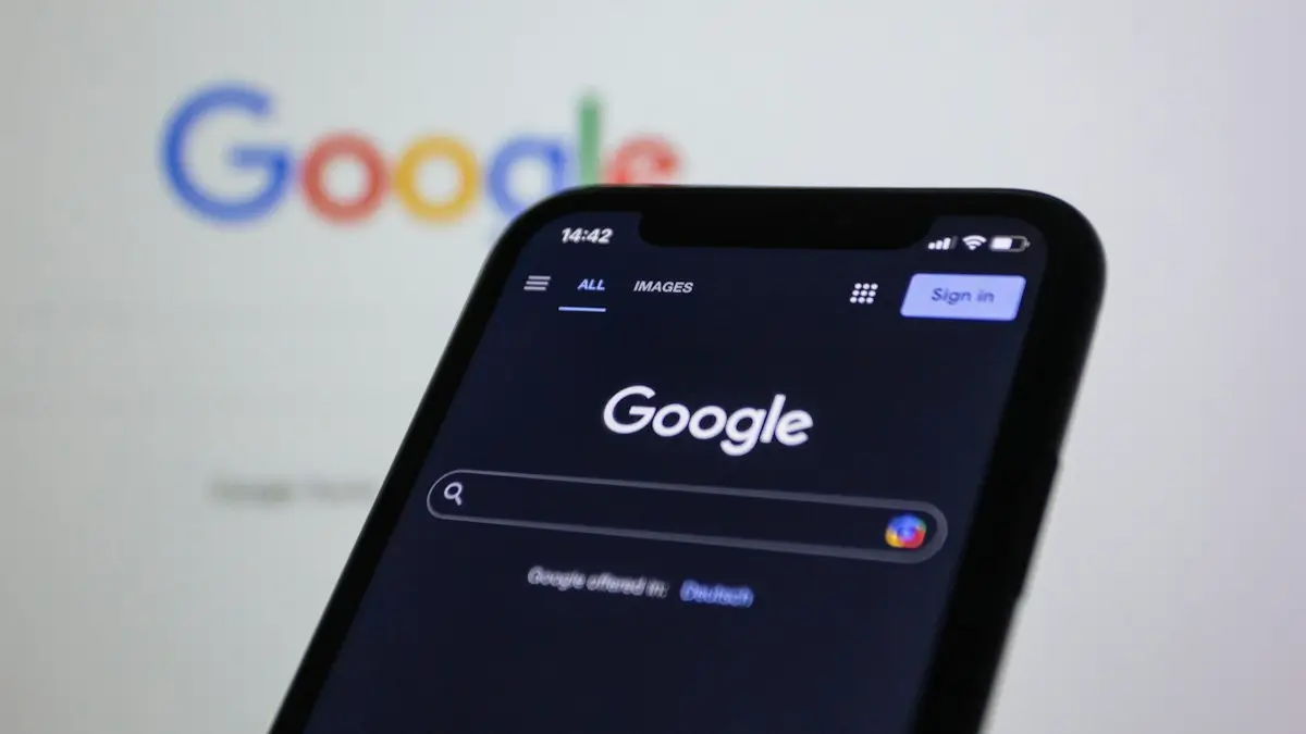 A close up of a cell phone with the google logo in the background