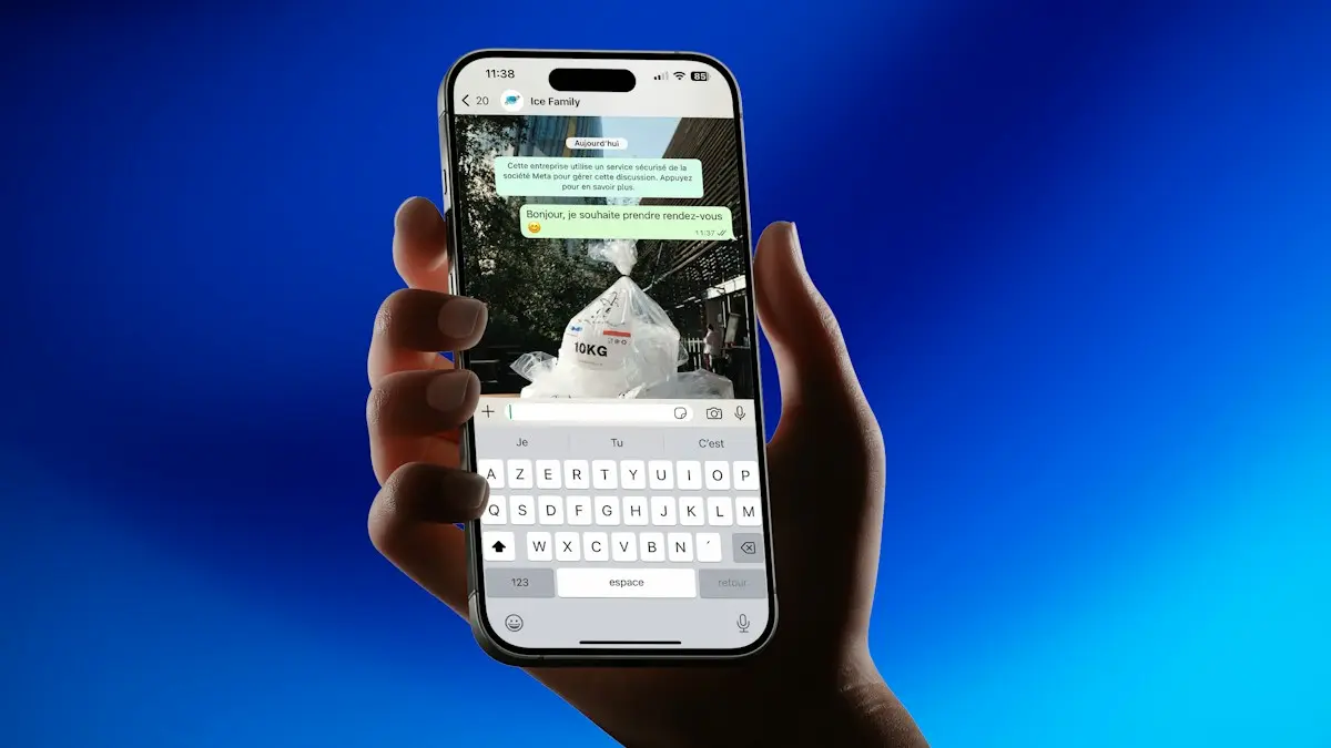 Hand holding smartphone showing messaging app