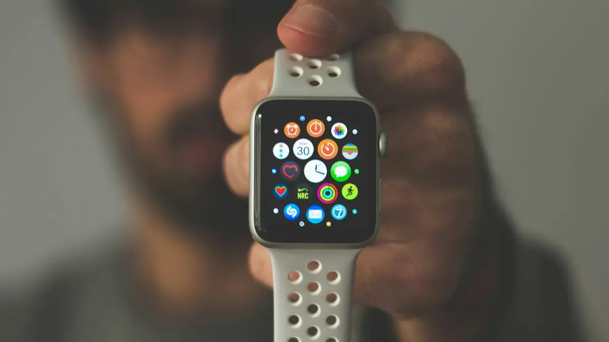 Person holding silver aluminum case Apple Watch