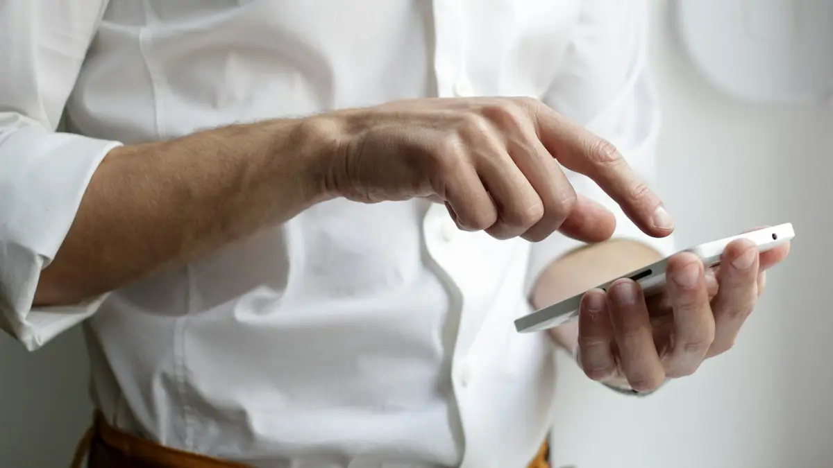 Person holding white Android smartphone in white shirt