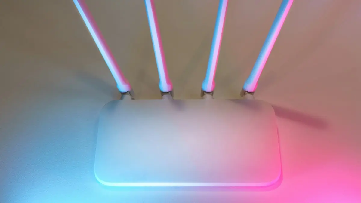 A white Wi-Fi router with four antennas