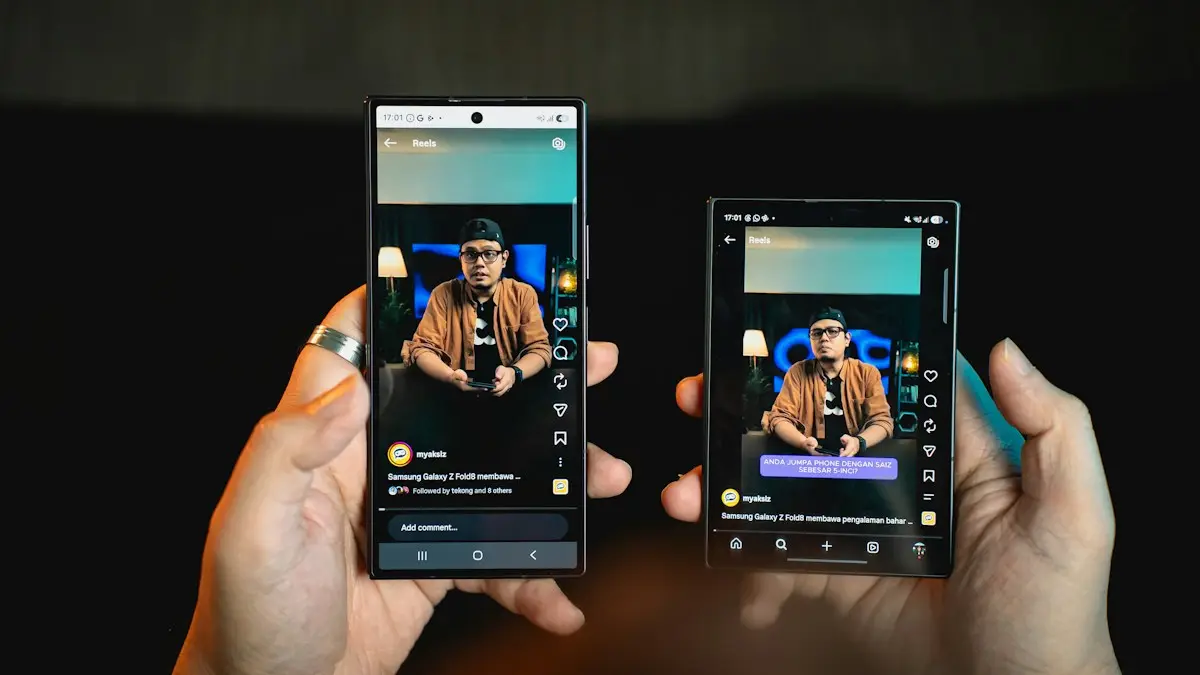 Hands holding two smartphones showing the same video