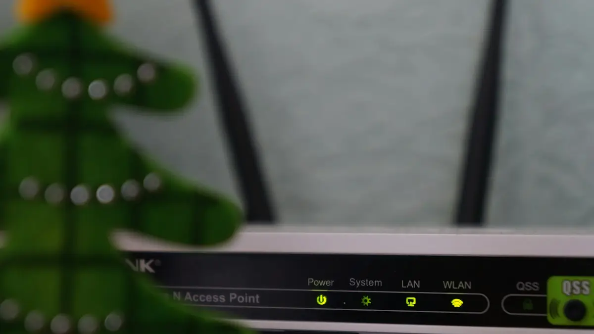 White and black modem router with four lights