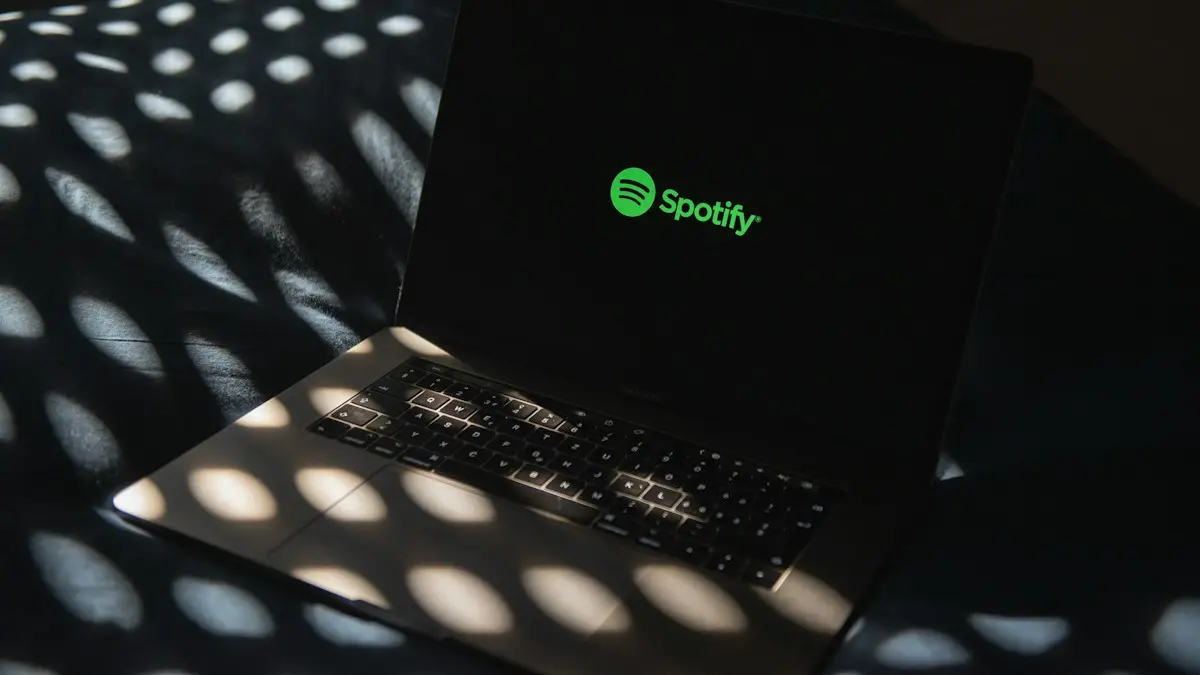 A laptop computer sitting on top of a bed