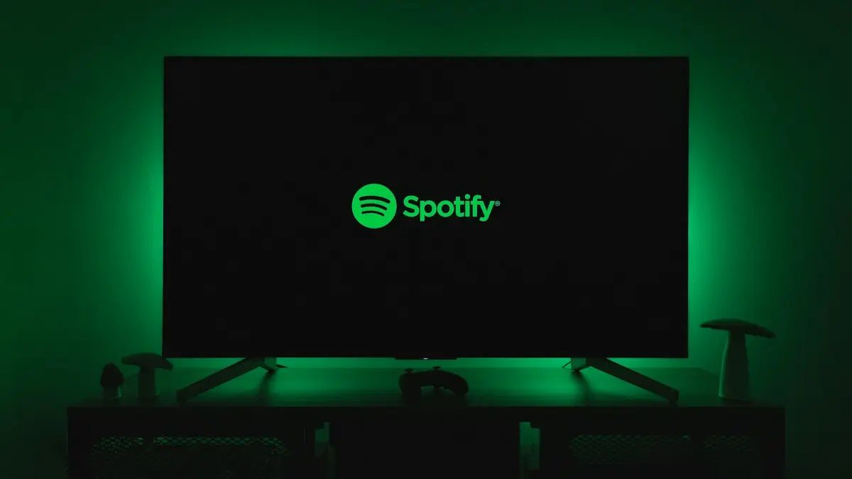 The spotify logo is lit up on a flat screen tv