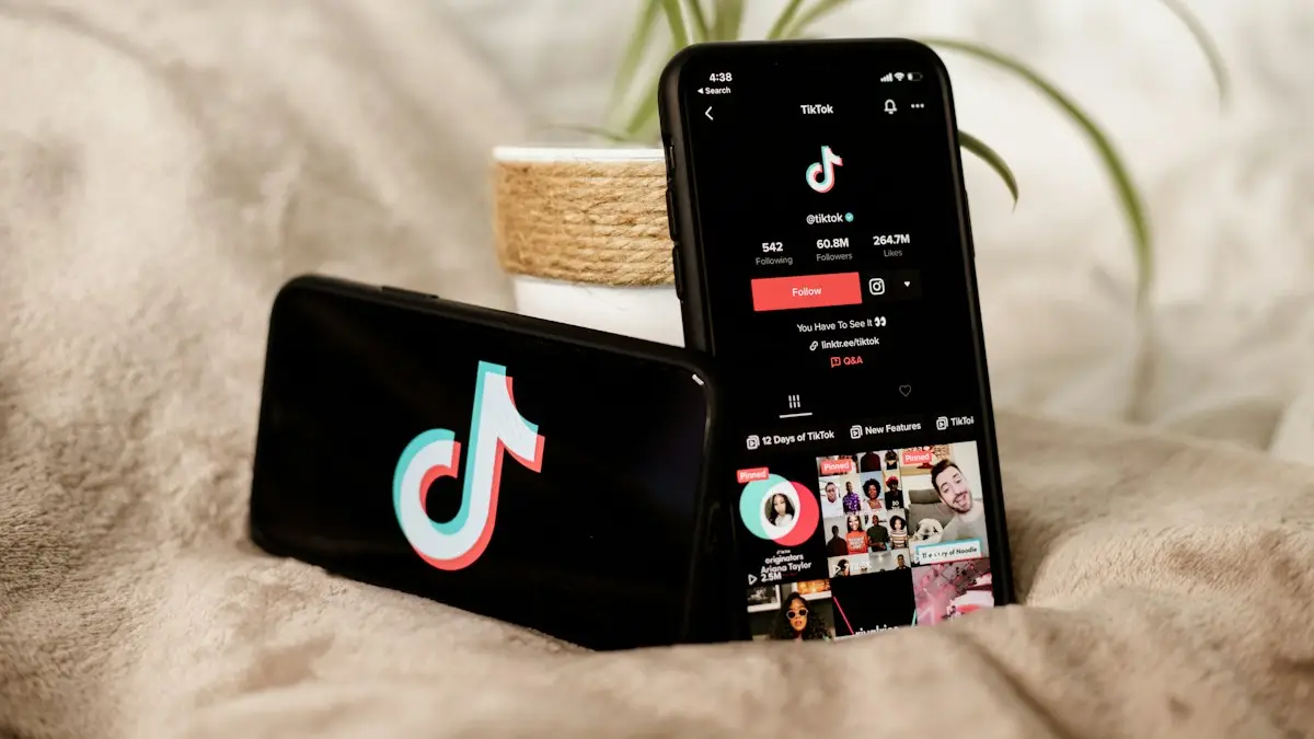 A couple of cell phones sitting on top of a bed