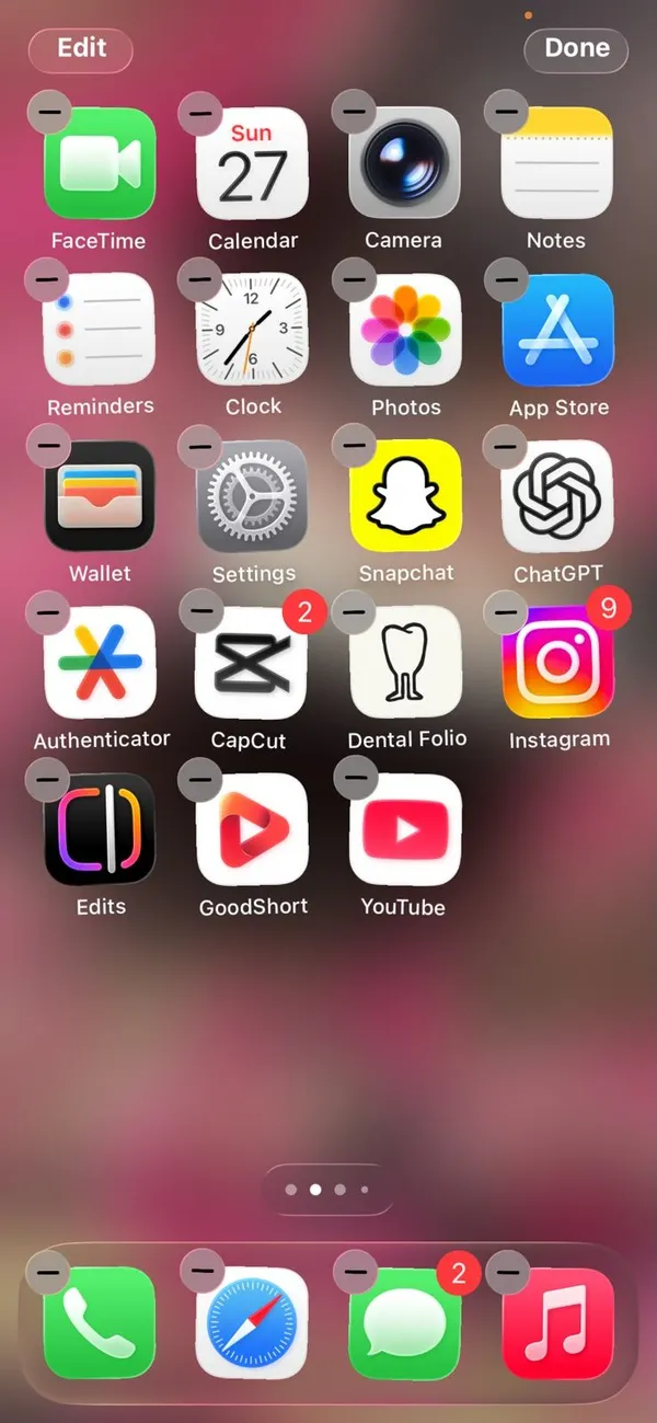 iPhone Home Screen in edit mode with jiggling app icons and the Edit button