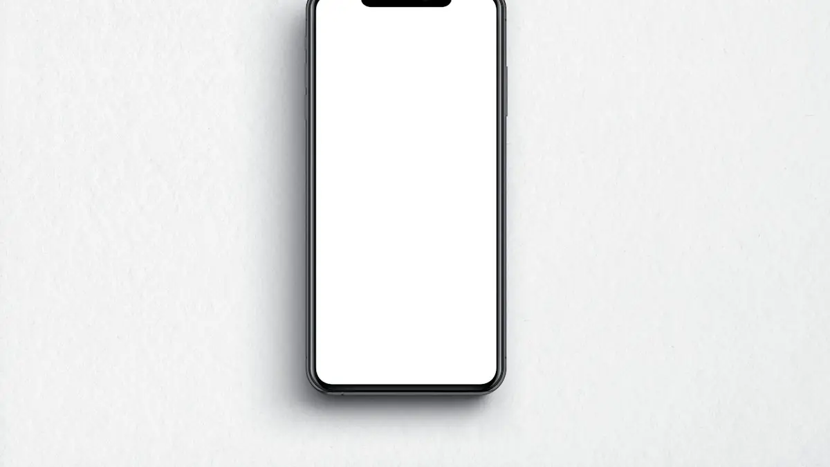 A black smartphone with a blank white screen on a textured white surface