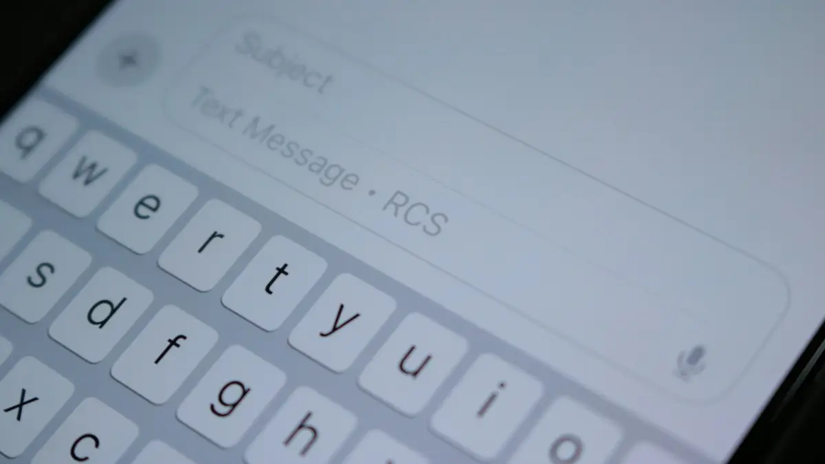 A close up of a cell phone with a keyboard