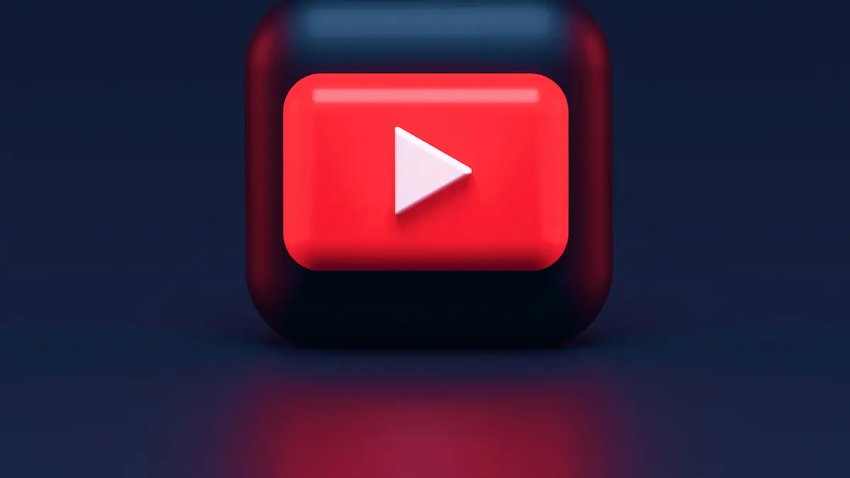 A 3D red play button icon on a dark blue background